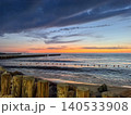 Wooden posts framing sunset seascape 140533908