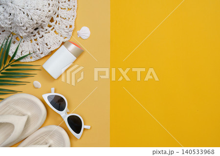 Summer vacation flat lay with beach essentials on yellow orange background 140533968