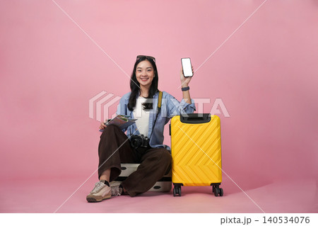 Asian woman traveler planning summer vacation with smartphone and map Asian woman traveler planning summer vacation with smartphone and map 140534076