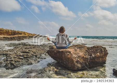 young woman relaxing on the beach 140534363
