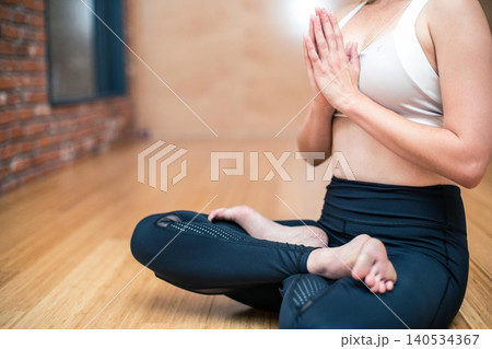 close up of woman making yoga exercises in fitness studio close up of woman making yoga exercises in fitness studio 140534367