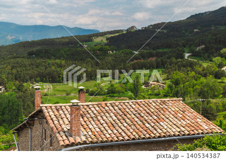 Traditional tiled roof house overlooking green valley in Catalonia, Spain Traditional tiled roof house overlooking green valley in Catalonia, Spain 140534387