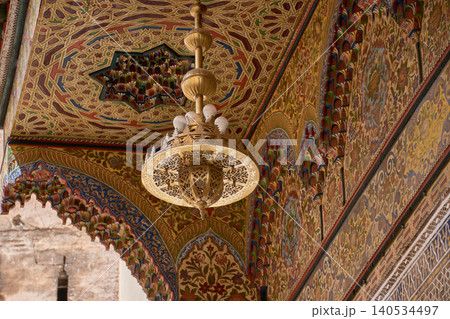 The interior of the Zaouia of Moulay Idriss II showcases its magnificent bronze chandelier and ornate ceilings in Fez The interior of the Zaouia of Moulay Idriss II showcases its magnificent bronze chandelier and ornate ceilings in Fez 140534497
