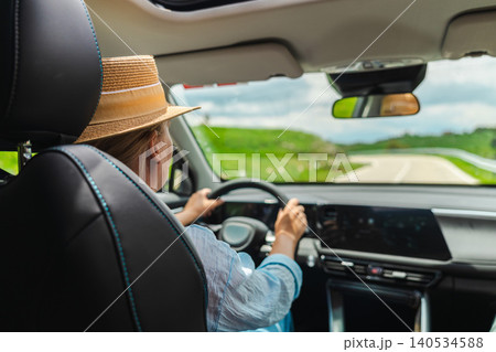 Woman driving scenic mountain road in Catalan Pyrenees viewed from car interior Woman driving scenic mountain road in Catalan Pyrenees viewed from car interior 140534588