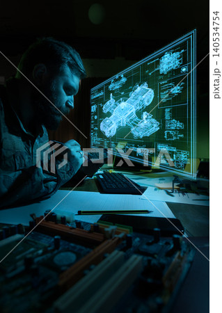 Engineer soldering electronic board while analyzing military blueprint hologram. Engineer soldering electronic board while analyzing military blueprint hologram. 140534754