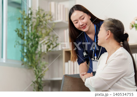 Friendly nurse providing care to elderly woman Friendly nurse providing care to elderly woman 140534755