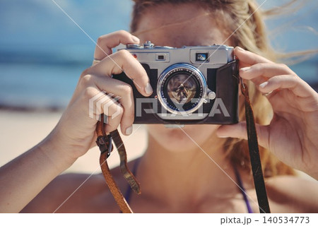 woman taking photo with retro camera woman taking photo with retro camera 140534773