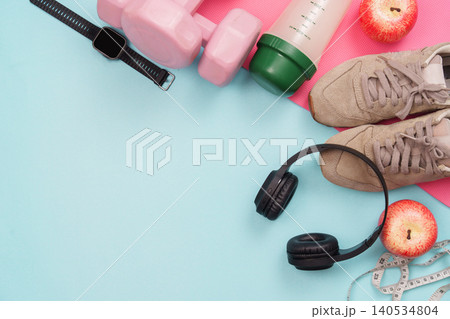 Fitness equipment flat lay with dumbbell smartwatch headphones apples Fitness equipment flat lay with dumbbell smartwatch headphones apples 140534804