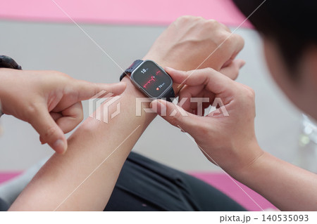 Asian person checking health data on smartwatch, fitness technology Asian person checking health data on smartwatch, fitness technology 140535093