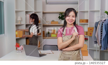 Confident Asian woman small business owner in home ecommerce office Confident Asian woman small business owner in home ecommerce office 140535327