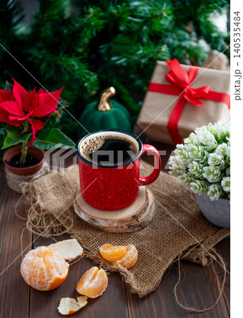 New Year's background: red mug with New Year's caramel, pine branches, pastel background, bokeh 140535484
