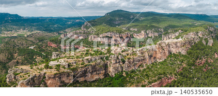 Close aerial view of Siurana village perched on towering sandstone cliffs in Catalonia, Spain. Close aerial view of Siurana village perched on towering sandstone cliffs in Catalonia, Spain. 140535650