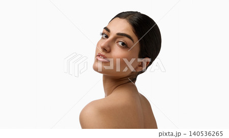 Elegant woman looking over shoulder with smooth radiant skin on white background. Elegant woman looking over shoulder with smooth radiant skin on white background. 140536265