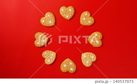 beautiful hand-baked cookies in the shape of a heart on a red background beautiful hand-baked cookies in the shape of a heart on a red background 140537073