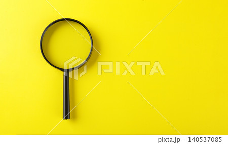 Magnifying glass on a yellow background 140537085