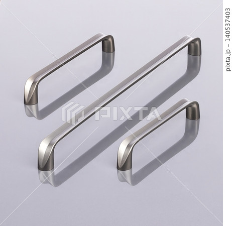 Metal handles are arranged in different sizes on a flat surface for display and selection purposes. Metal handles are arranged in different sizes on a flat surface for display and selection purposes. 140537403