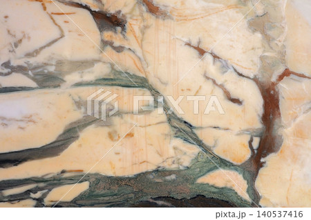 Marble surface with green and brown veining in indoor setting during daylight 140537416