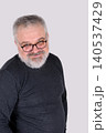Friendly mature bearded man wearing glasses and smiling at camera 140537429