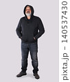 Mature bearded man in hoodie standing with hands in pockets 140537430
