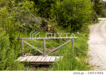 small rustic wooden bridge crossing a stream small rustic wooden bridge crossing a stream 140537668