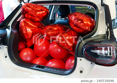 Romantic surprise with ed heart-shaped balloons in an open car trunk Romantic surprise with ed heart-shaped balloons in an open car trunk 140538046
