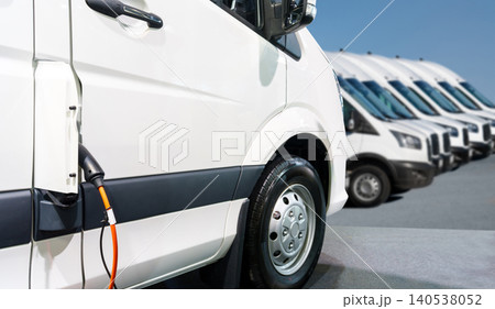 Close up of electric delivery van with connected charging cable Close up of electric delivery van with connected charging cable 140538052