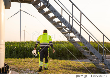 Maintenance engineer works close to wind turbine Maintenance engineer works close to wind turbine 140538065