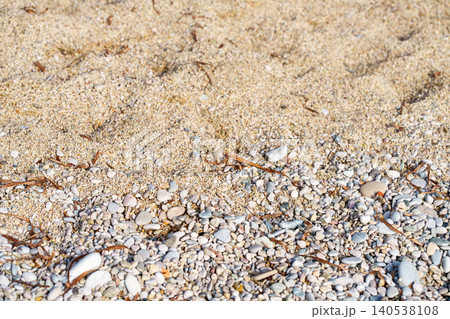 Close-up of sea sand and colorful pebbles on a beach. Close-up of sea sand and colorful pebbles on a beach. 140538108