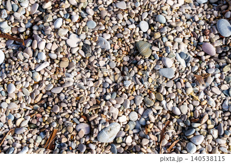 Close-up of sea sand and colorful pebbles on a beach. Close-up of sea sand and colorful pebbles on a beach. 140538115