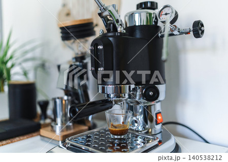 Home barista corner with a manual lever espresso machine and a single dose coffee grinder Home barista corner with a manual lever espresso machine and a single dose coffee grinder 140538212