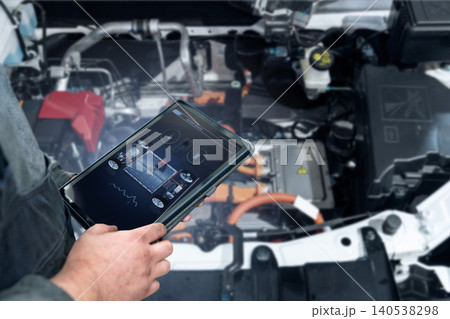 Serviceman with tablet checks car software in car service Serviceman with tablet checks car software in car service 140538298