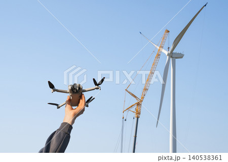 Engineer with drone for wind turbines inspection 140538361