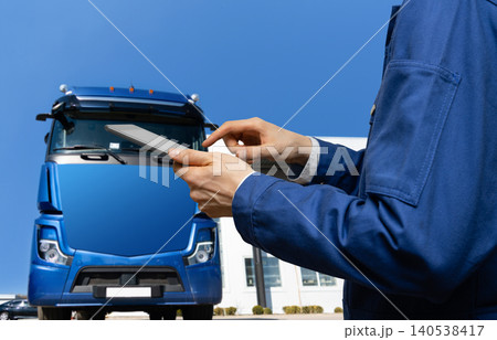 Manager with a digital tablet next to truck. Fleet management. Manager with a digital tablet next to truck. Fleet management. 140538417
