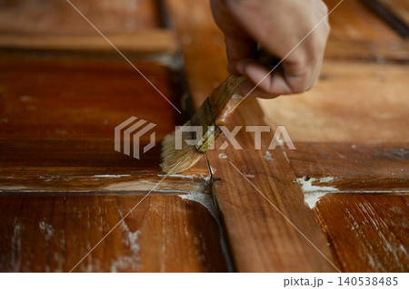 hand applying stain on wood hand applying stain on wood 140538485