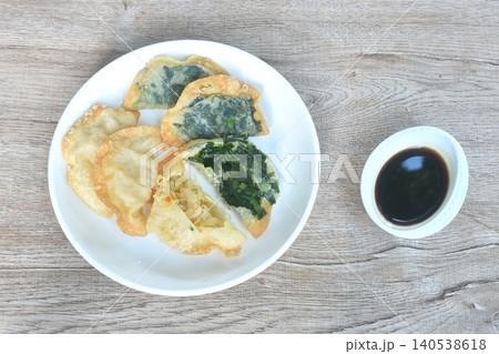 deep fried Guizhou of dumpling stuffed slice garlic chive and chop cabbage on plate dipping spicy black soy sauce 140538618