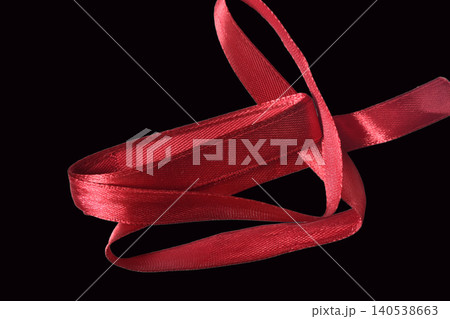 Red satin ribbon for gift wrapping. Red satin ribbon for gift wrapping. 140538663