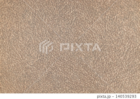 A light brown textured leather surface showing fine natural grain details A light brown textured leather surface showing fine natural grain details 140539293