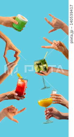Hands holding colorful cocktails with gesture signs on blue background. Hands holding colorful cocktails with gesture signs on blue background. 140539417