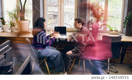 Focused office workers having one on one business conversation in coworking space. 140539553