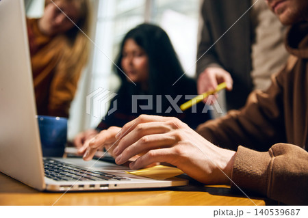 Close up of hands typing on laptop during business planning session. 140539687