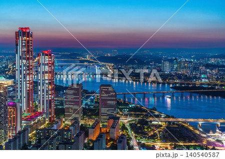 High-angle panoramic view of Yeouido financial district skyscrapers at sunset in Seoul, South Korea. High-angle panoramic view of Yeouido financial district skyscrapers at sunset in Seoul, South Korea. 140540587