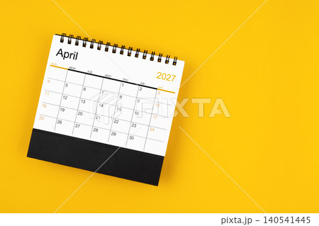 April  2027 desk calendar on yellow background, position with copy space. 140541445