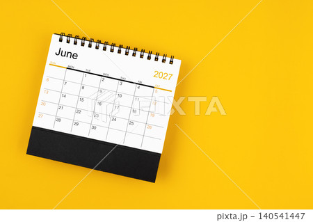 June 2027 desk calendar on yellow background, position with copy space. June 2027 desk calendar on yellow background, position with copy space. 140541447