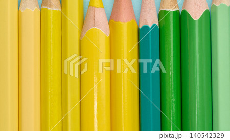 Close-up of a row of green and yellow wooden pencils Close-up of a row of green and yellow wooden pencils 140542329