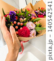 Close Up Hand Holding Colorful Mixed Bouquet Indoors With Reflection 140542541