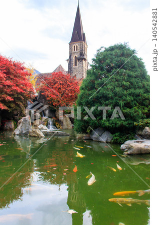 Catholic Church of St. Joseph and artificial pond with fish at autumn in Interlaken, Switzerland Catholic Church of St. Joseph and artificial pond with fish at autumn in Interlaken, Switzerland 140542881