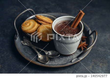 Traditional Mexican champurrado hot drink in a cup with cookies, cinnamon stick, and star anise Traditional Mexican champurrado hot drink in a cup with cookies, cinnamon stick, and star anise 140542977