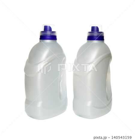 two white plastic bottles of household chemicals stand next to each other in center of frame two white plastic bottles of household chemicals stand next to each other in center of frame 140543159