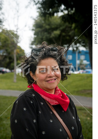 A woman wearing a red bandana and sunglasses is smiling A woman wearing a red bandana and sunglasses is smiling 140543375