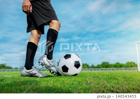 Soccer Player Kicking Ball Close-up, Football Striker Action Bokeh, Male Athlete Kicking Football Soccer Player Kicking Ball Close-up, Football Striker Action Bokeh, Male Athlete Kicking Football 140543455